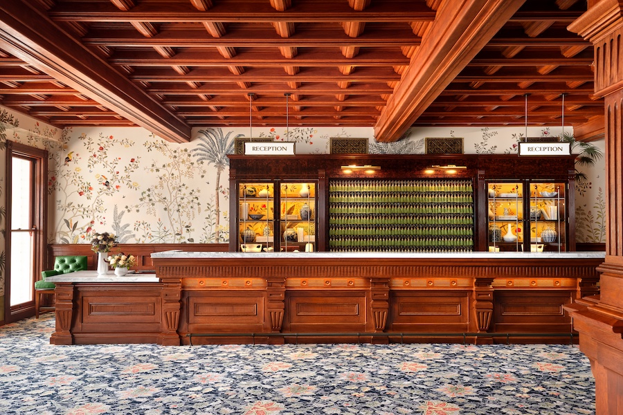 Hotel del Coronado california restoration lobby wood coffered ceiling millwork wainscoting floral carpet reception desk hotel keys
